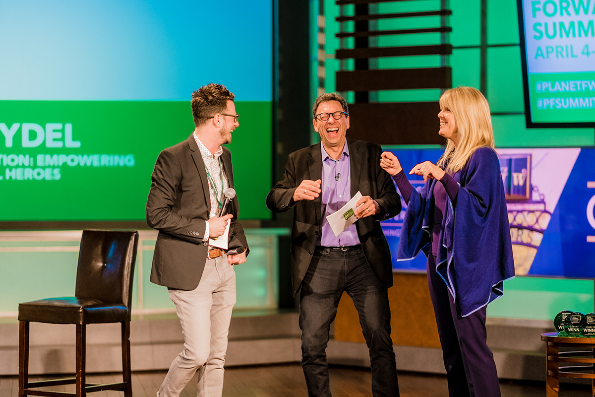 Planet Forward Director Dan Reed laughs with Frank Sesno and Captain Planet Foundation Chairperson Laura Turner Seydel, after singing the Captain Planet theme song.